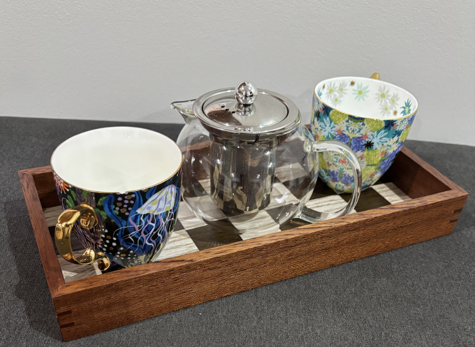 Checker-pattern veneer serving tray with teacups